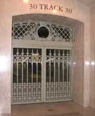 Three sets of cast and wrought iron doors with decorative transom panels were copied for for new train openings in the Grand Central Terminal in New York City.