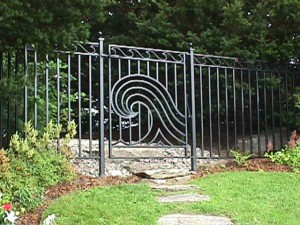 Wrought iron swimming pool fence enclosure and gates at private residence designed by Hugh J. Collins Jr. Landscape Designer, Inc. 