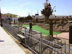 Wrought iron fence at mini-golf amusement park.